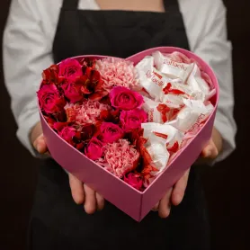 розовые розы, красные альстромерии, розовые гвоздики и конфеты Raffaello в коробке в форме сердца
