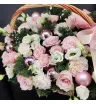 композиция из роз, эустомы, гвоздик, хвойной зелени и розовых декоративных шаров в корзине