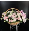 композиция из роз, эустомы, гвоздик, хвойной зелени и розовых декоративных шаров в корзине